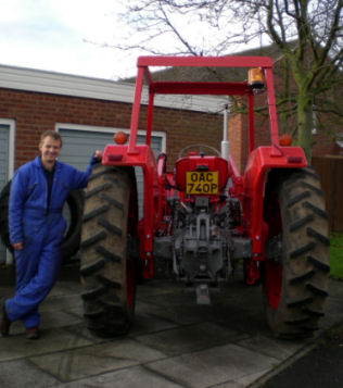 Proud Stephen in front of his tractor